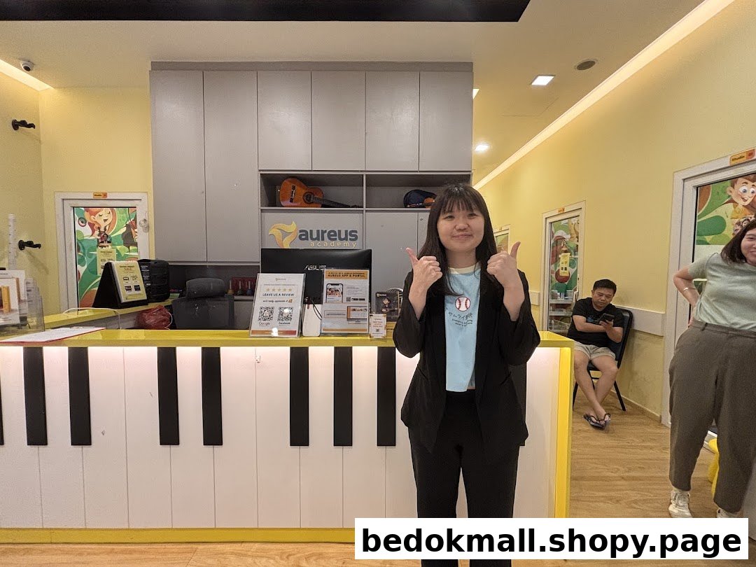 Interior shot of Aureus Academy with a piano-themed reception desk and people.
