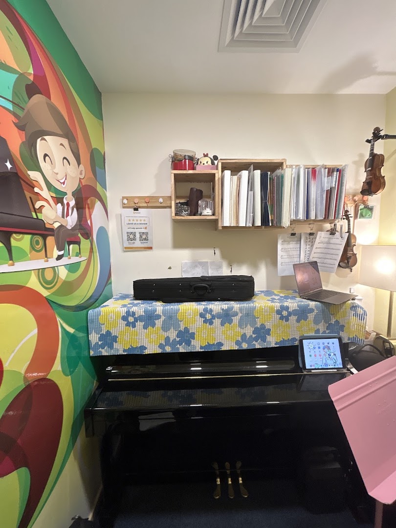 Music room interior with a piano, violins, music sheets, and a colorful mural.