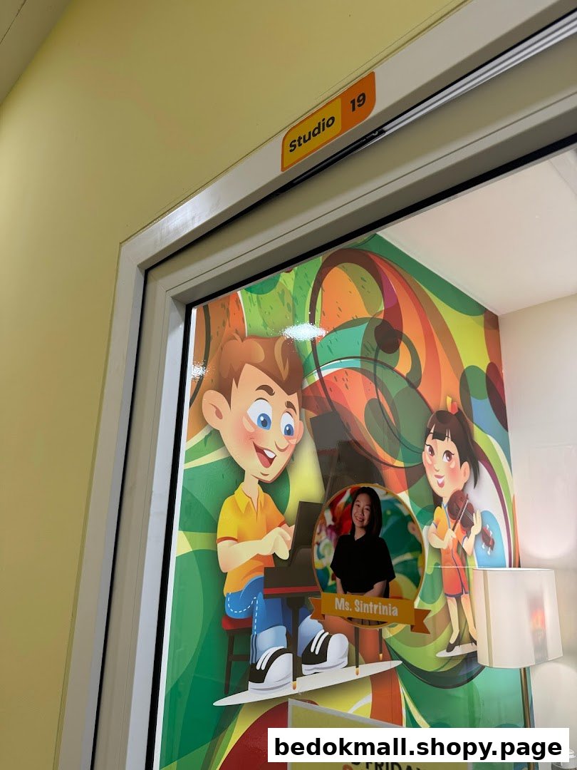 A studio door with cartoon graphics of children and a teacher's photo.