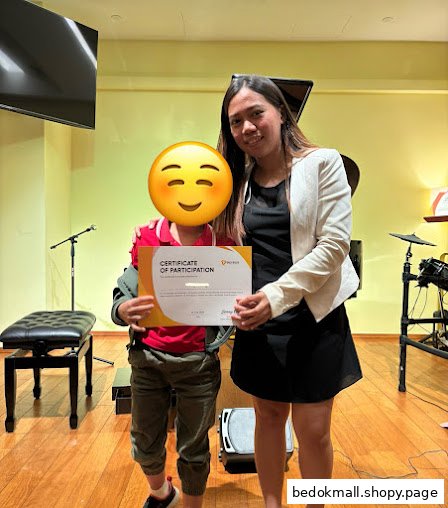 Two people holding a certificate in a music room setting.