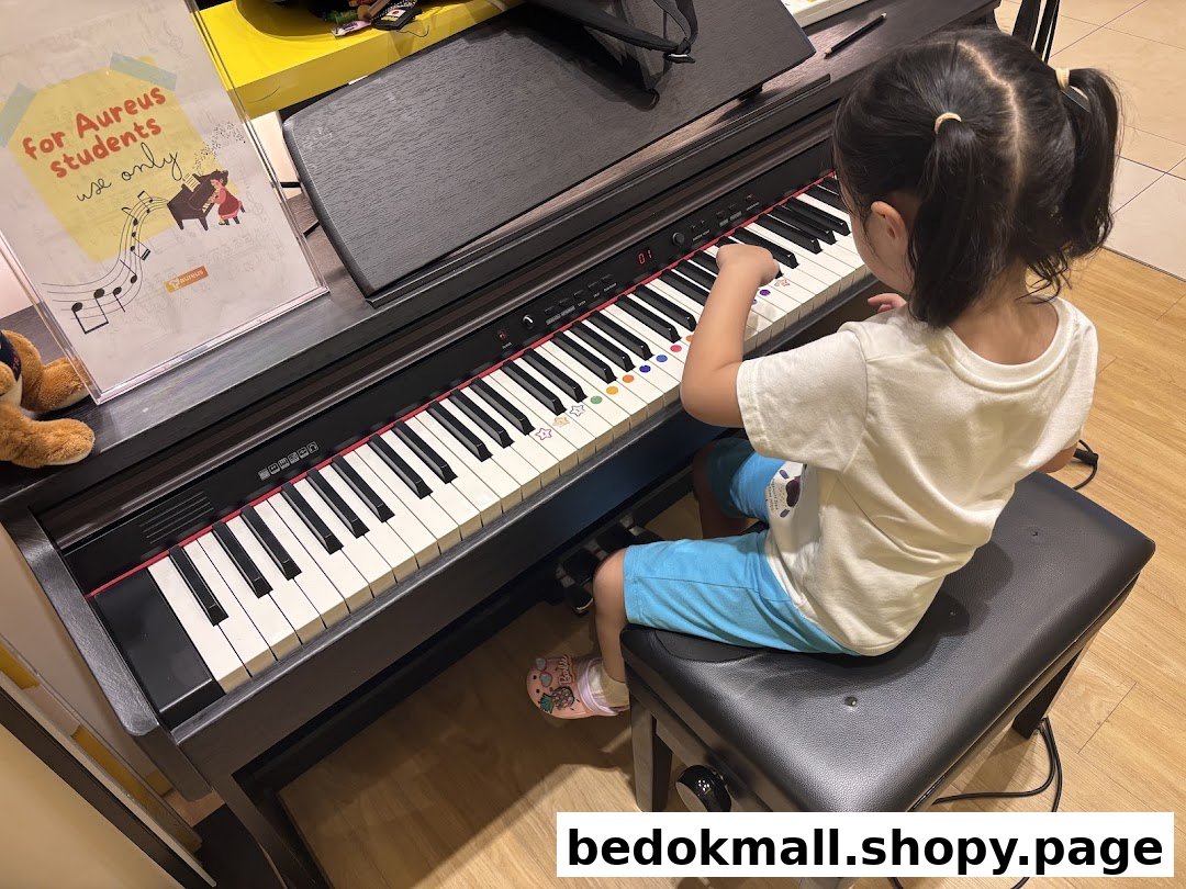 Young child playing a digital piano at a music academy.