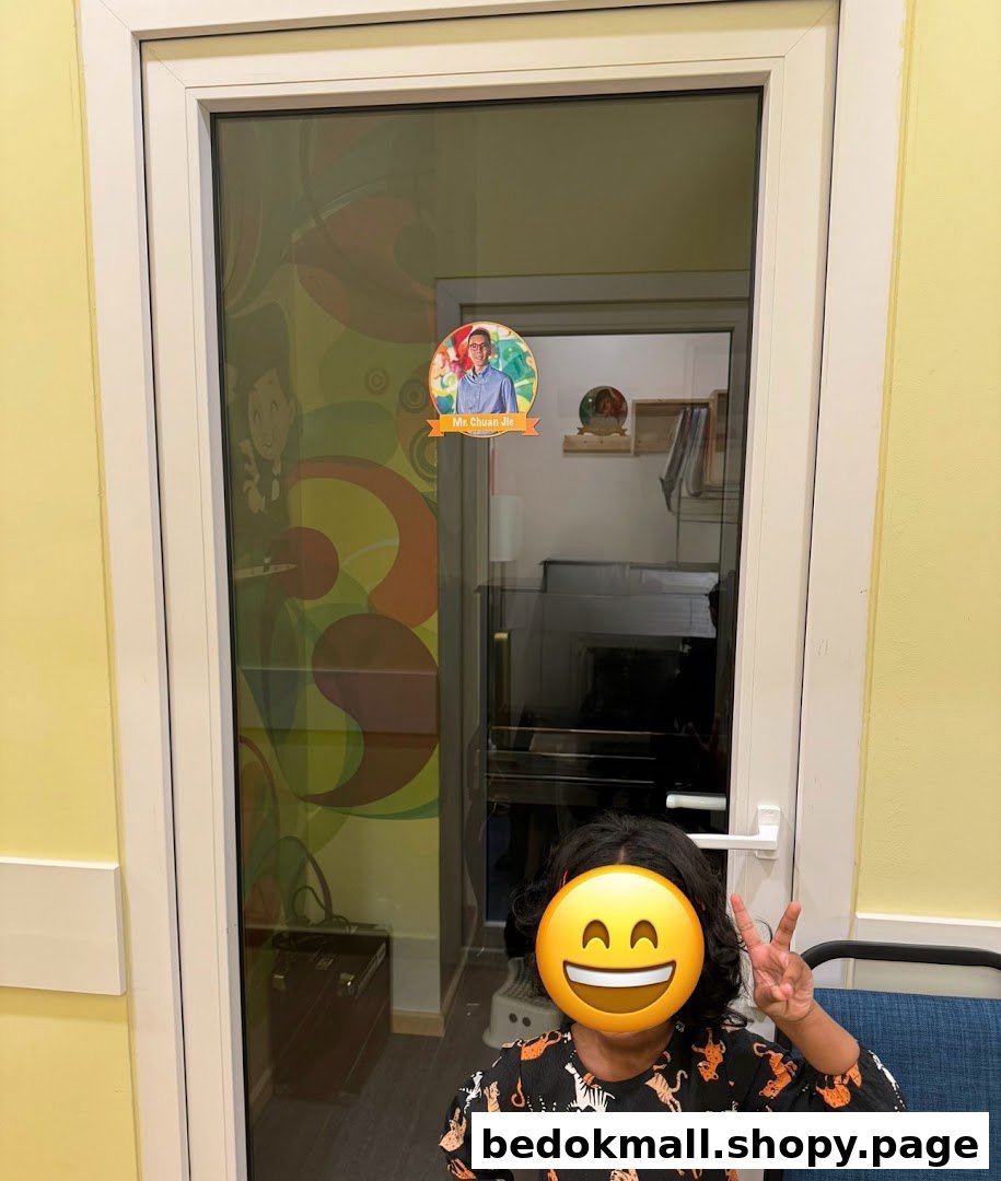 Child stands in front of a glass door leading to a colorful interior room.