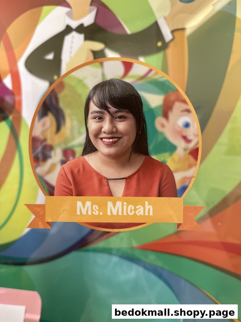 A smiling woman's photo labeled 'Ms. Micah' on a colorful background.