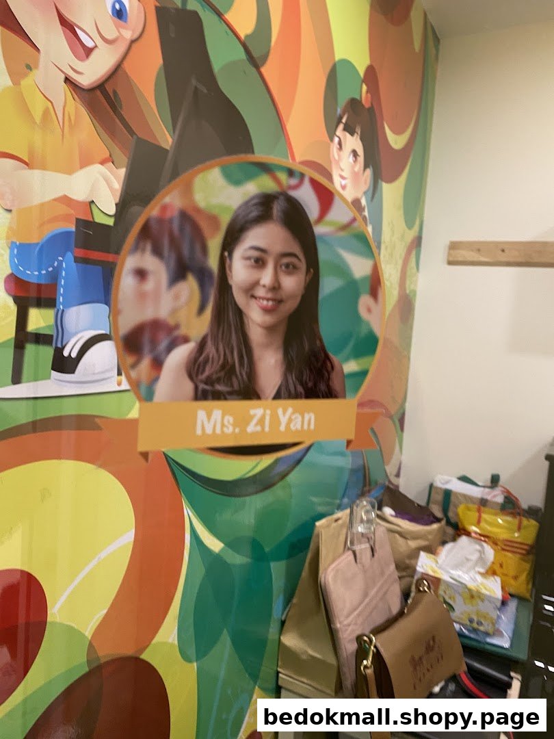 Colorful wall with a photo of Ms. Zi Yan and bags in a shop interior.