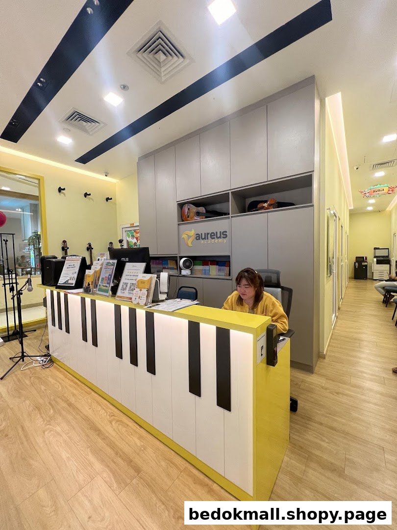 Interior of Aureus Academy with a piano-themed reception desk and staff.
