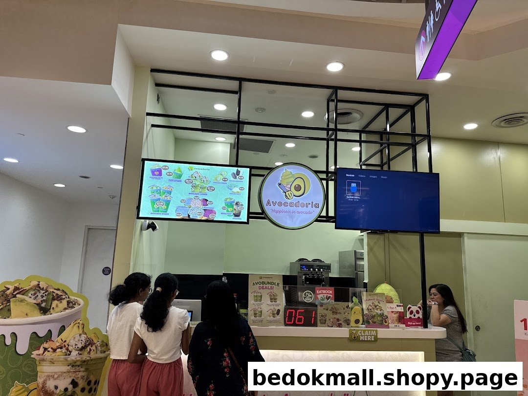 Avocadoria shop interior showing customers at the counter and a digital menu.
