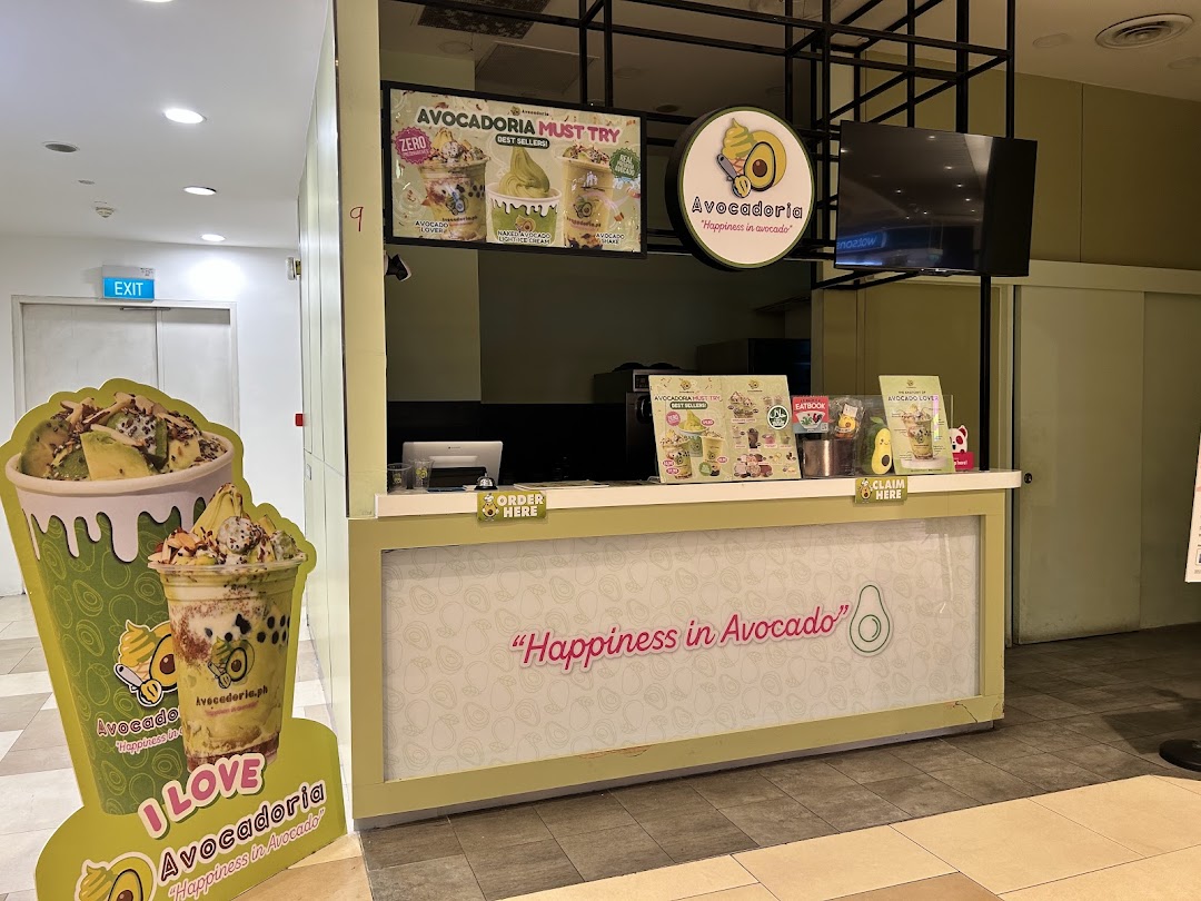 Avocadoria shop counter with menus, a large product standee, and ordering area.