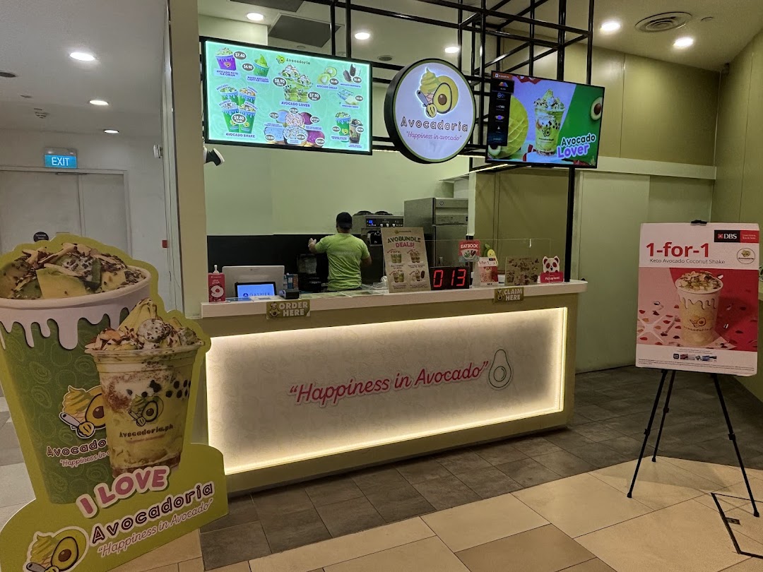 Shop counter with staff, digital menus, and promotional displays.