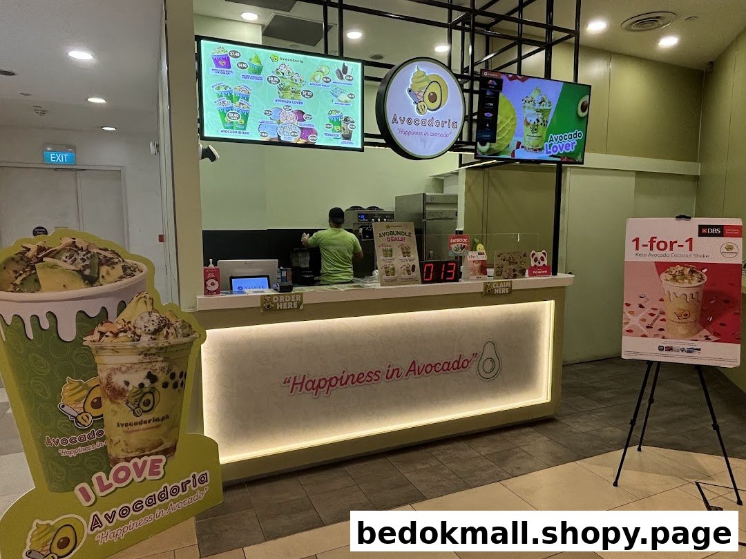 Shop counter with staff, digital menus, and promotional displays.