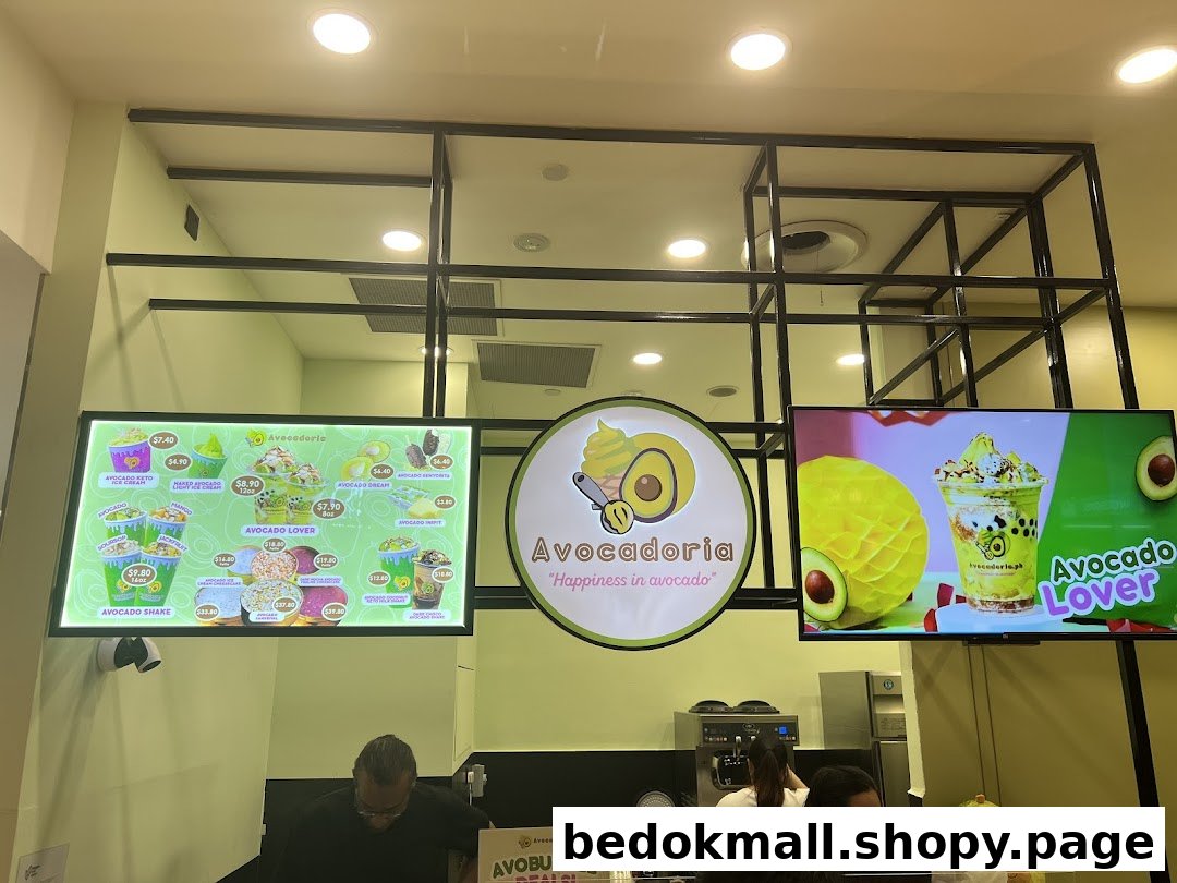 Interior view of Avocadoria shop with digital menus, counter, and staff.