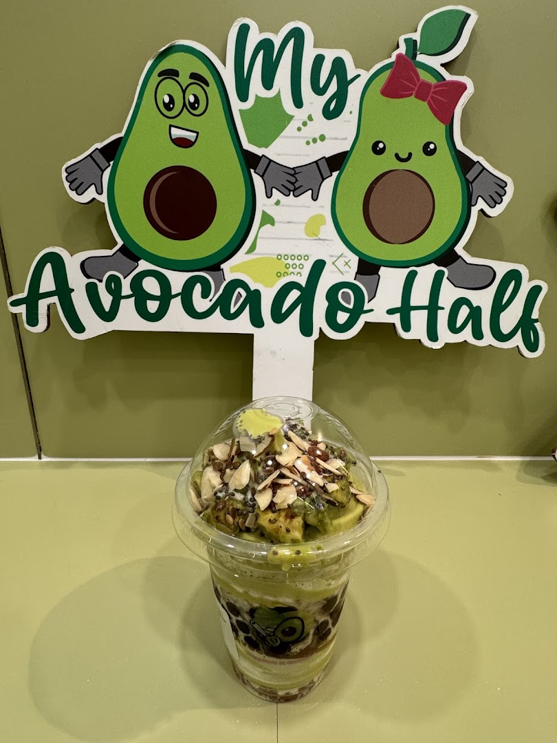 An avocado drink with toppings sits in front of a 'My Avocado Half' sign.