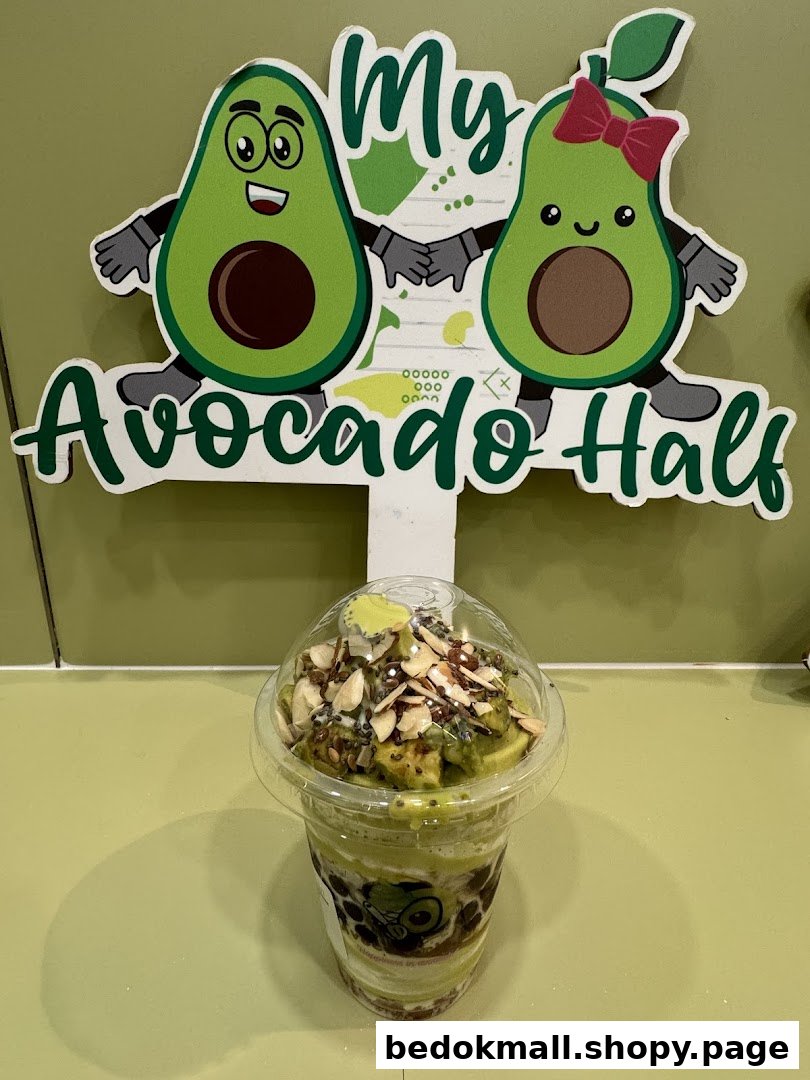An avocado drink with toppings sits in front of a 'My Avocado Half' sign.