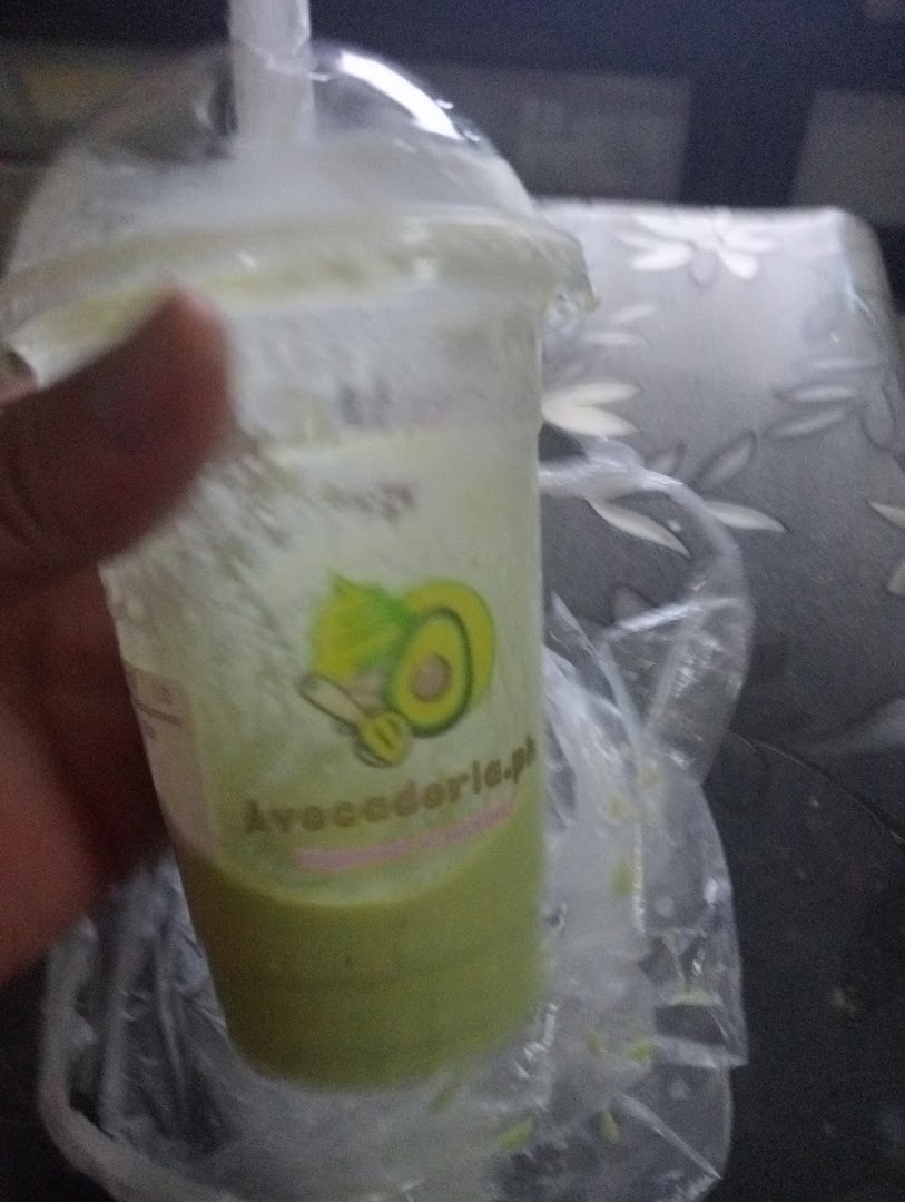 Close-up of a hand holding an avocado drink from Avocadoria.