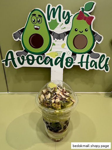 Avocado drink with toppings in front of a 'My Avocado Half' sign.