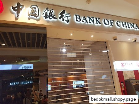 Exterior of Bank of China branch with security shutter and ATM.