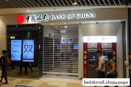 Entrance of Bank of China with a closed security shutter and ATMs.