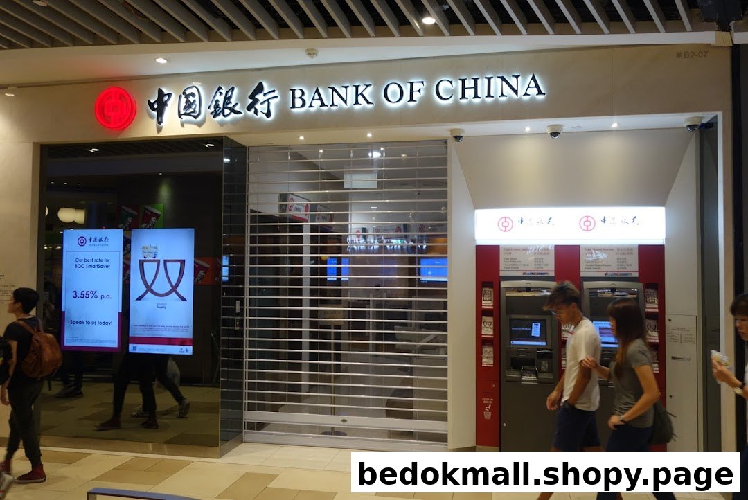 Exterior view of Bank of China branch with closed shutter and ATMs.