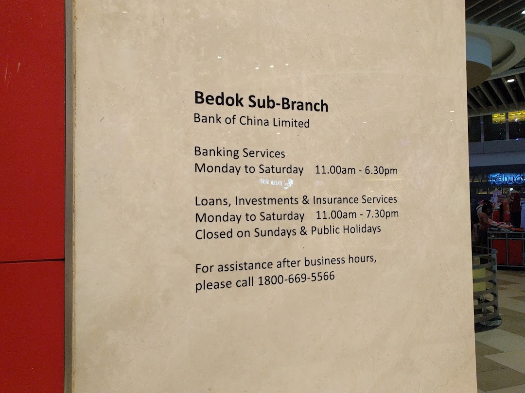 A sign displaying the operating hours and services of Bank of China Bedok Sub-Branch.