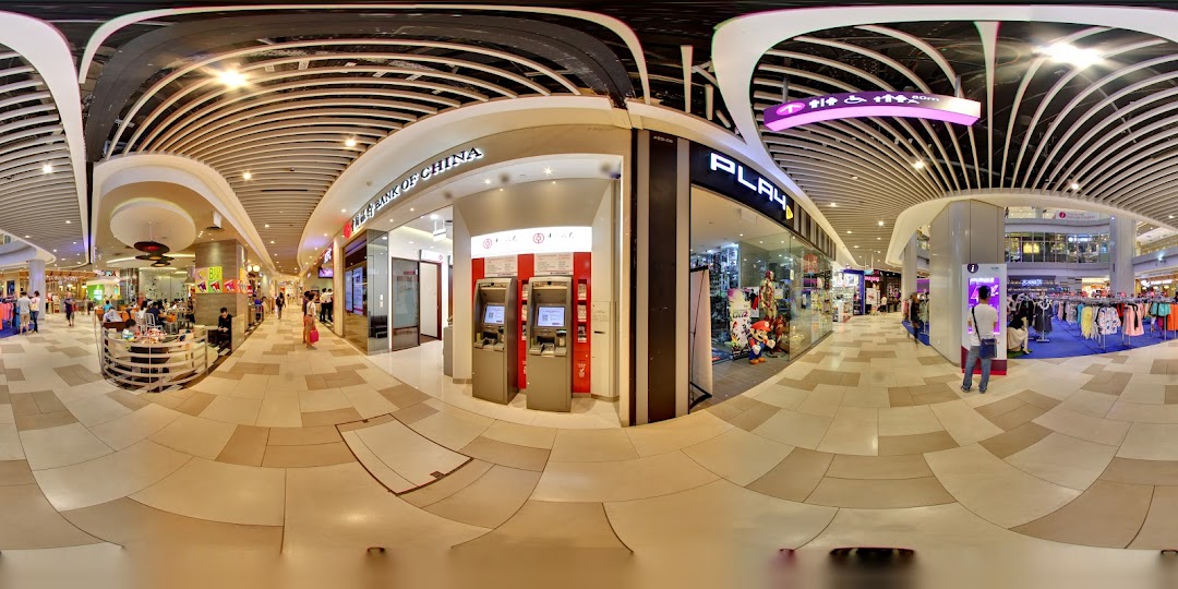 Interior view of a shopping mall with Bank of China ATMs and other shops.