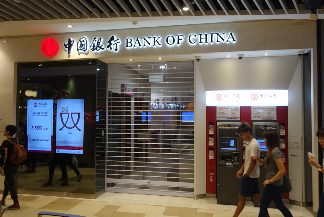 Exterior view of Bank of China with closed shutter and ATMs.