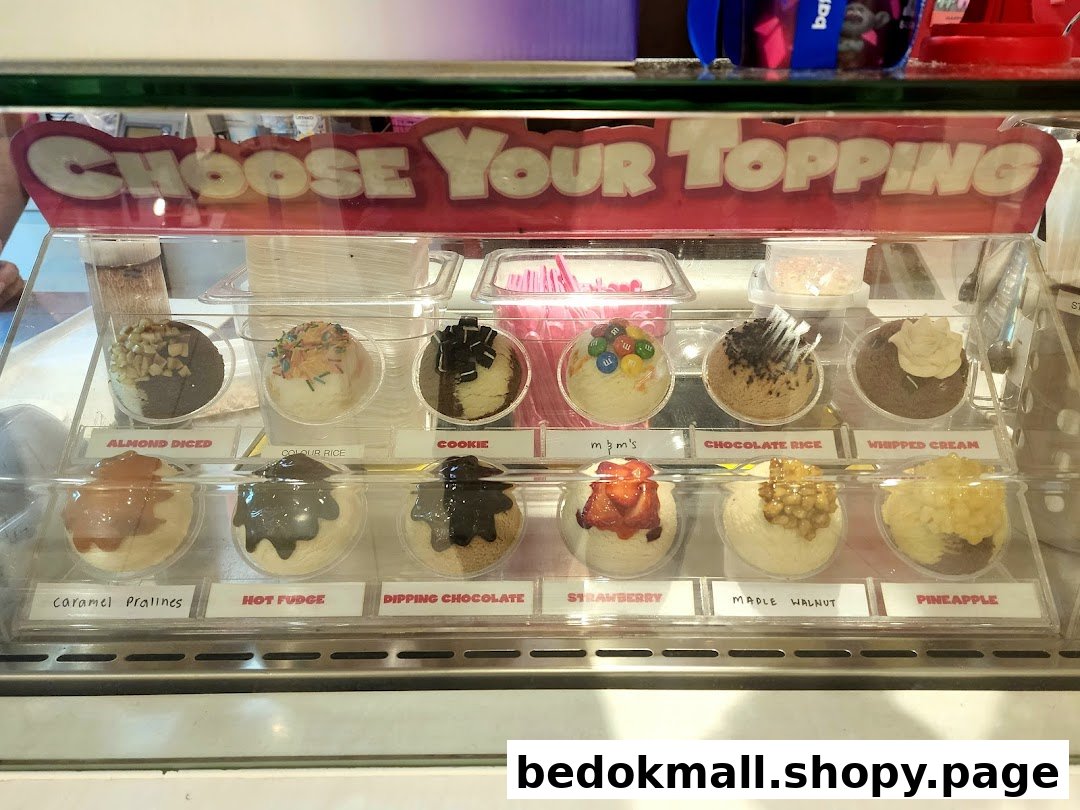 Display case showing various dessert toppings with labels.