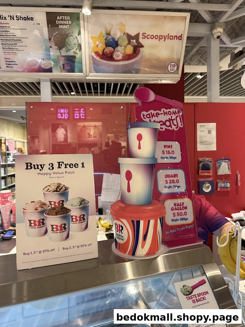 Interior view of an ice cream shop counter with menus and promotional displays.