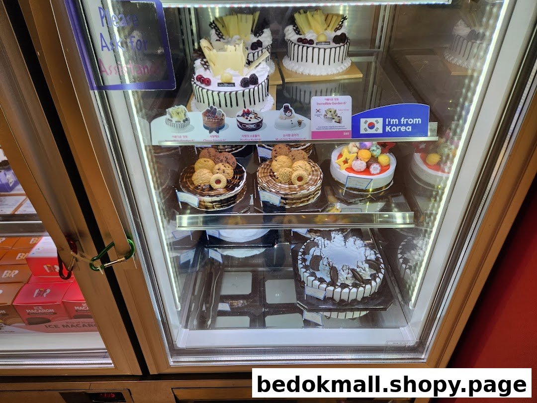 A refrigerated display case showcasing various cakes and desserts.