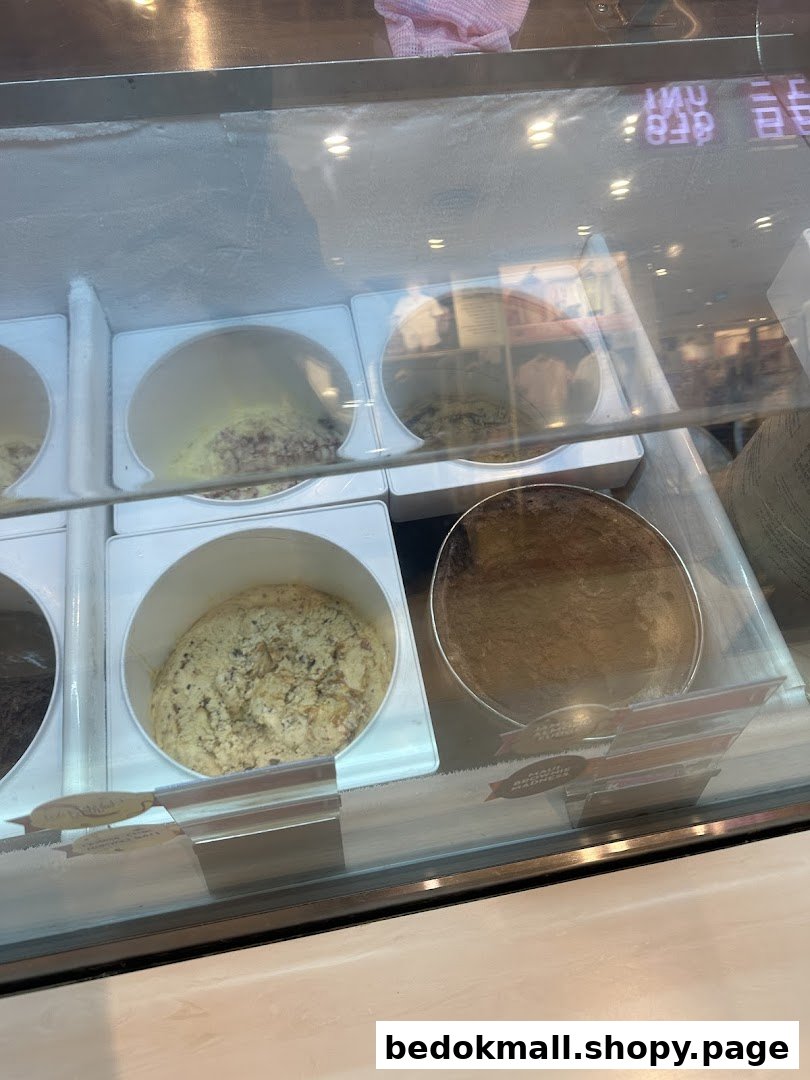Close-up view of various ice cream flavors in a display freezer.