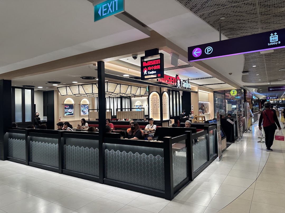 Interior view of a ramen restaurant dining area with customers in a mall.