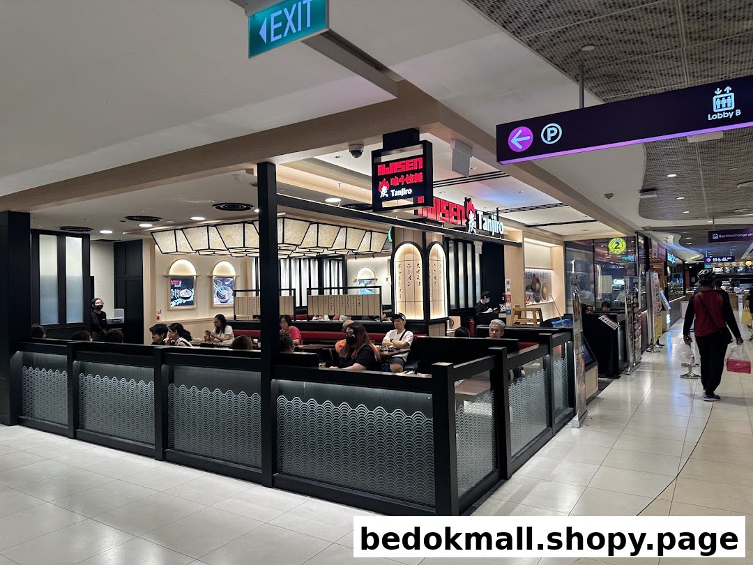 Interior view of a ramen restaurant dining area with customers in a mall.