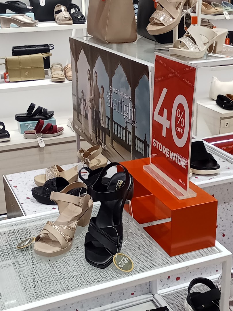 Interior shot of a Bata store displaying shoes, bags, and a 40% off sign.