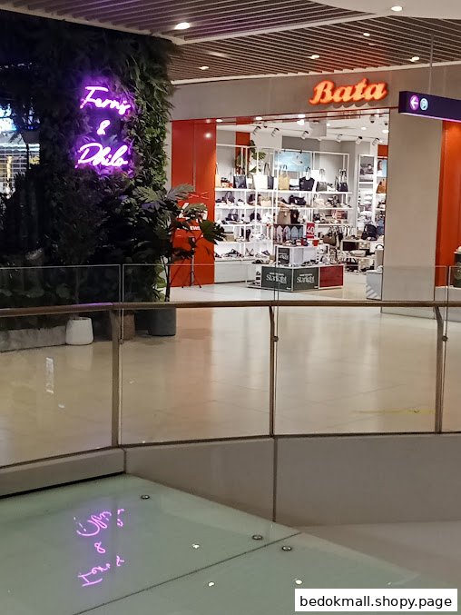 Bata shop entrance displaying shoes and bags inside a mall.