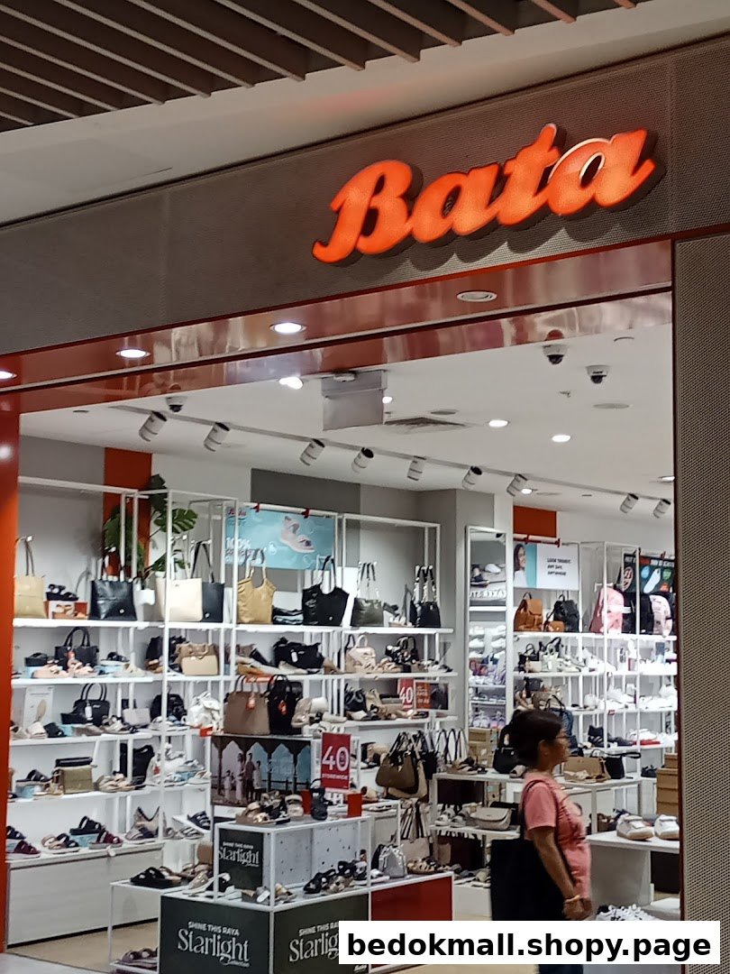 The image shows the illuminated Bata shop front with shoes and bags visible inside.