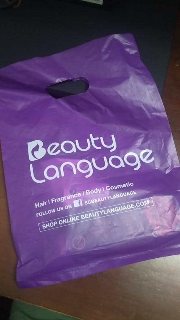 A purple shopping bag with "Beauty Language" logo and text.