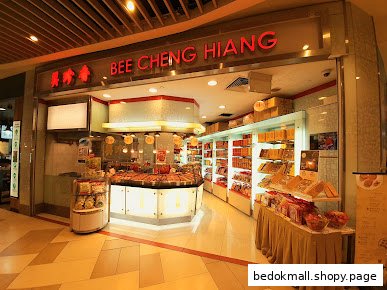 Storefront of Bee Cheng Hiang shop with products displayed inside.