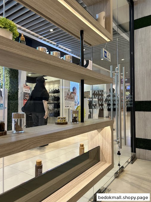 Interior view of a shop with display shelves and glass entrance.