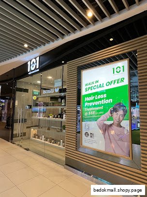 Shop entrance with a large promotional display for hair loss treatment.