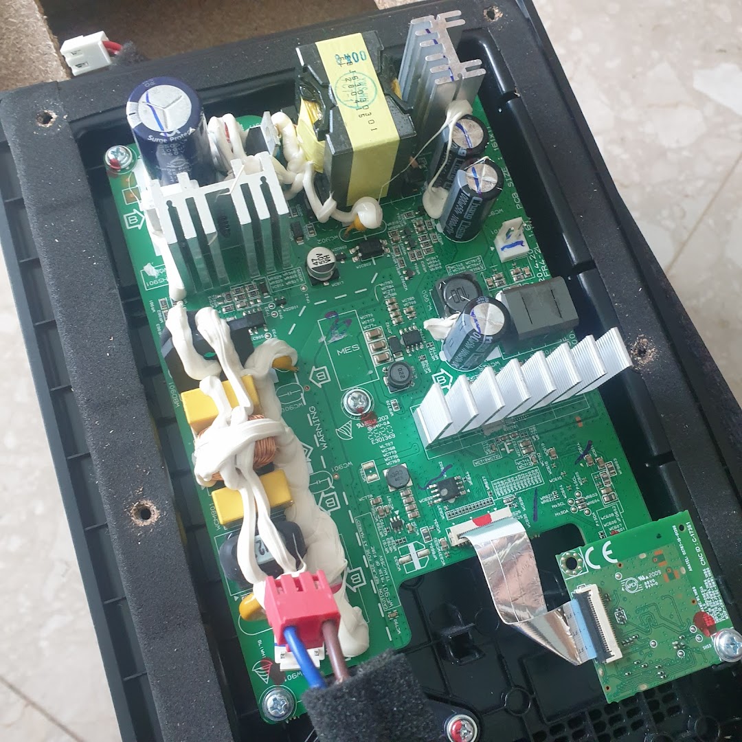 Close-up of an electronic circuit board with various components inside a casing.