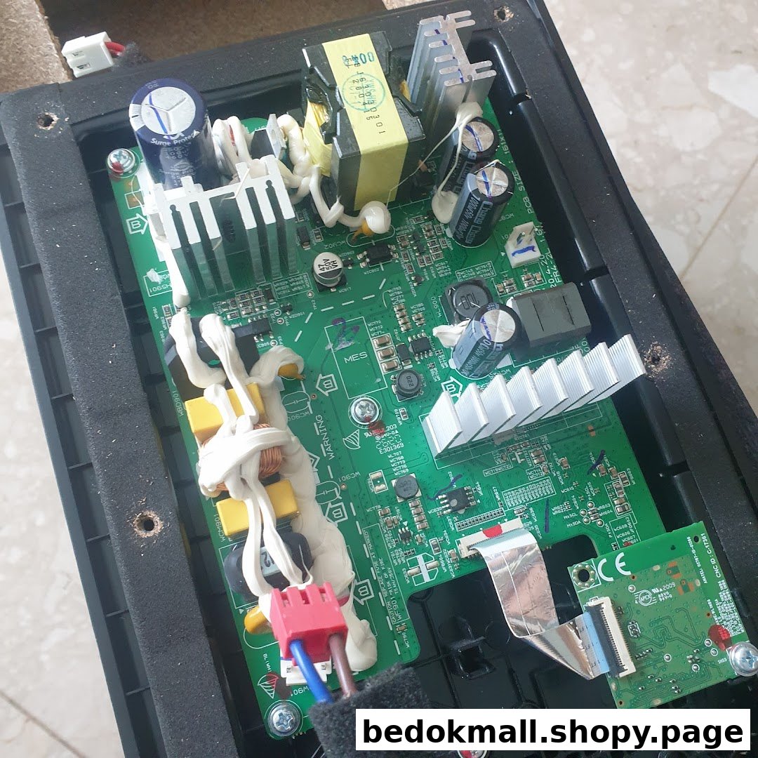 Close-up of an electronic circuit board with various components inside a casing.