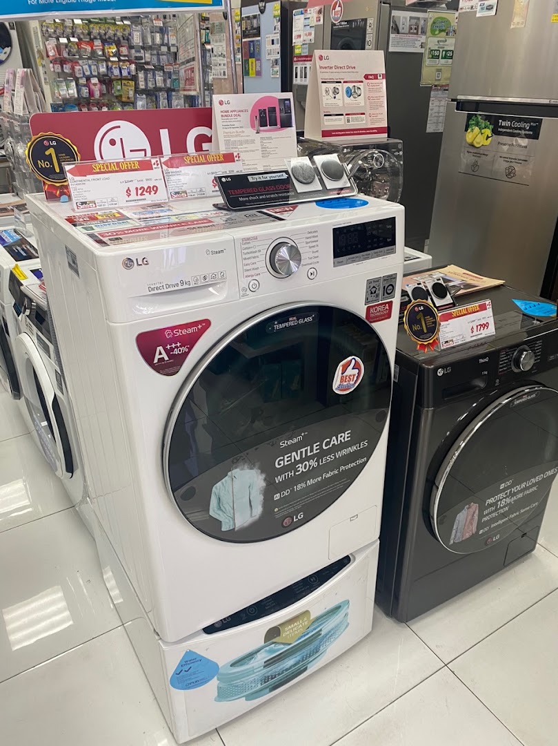 Interior shot of an electronics store displaying washing machines and refrigerators.