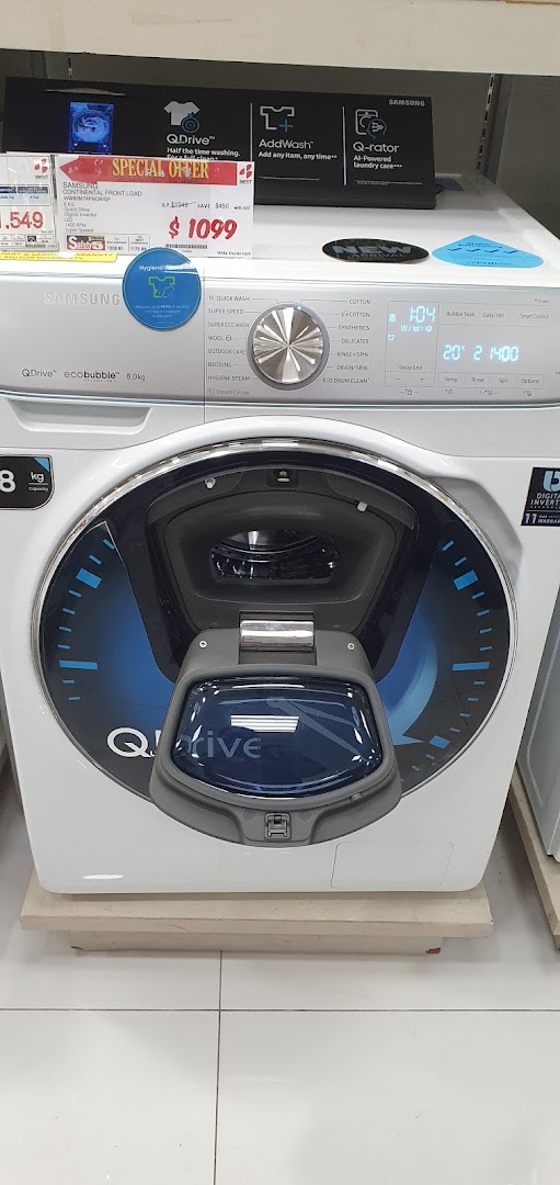 A Samsung washing machine on display with a price tag in a retail store.