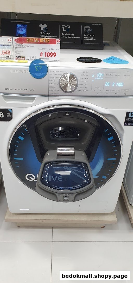 A Samsung washing machine on display with a price tag in a retail store.