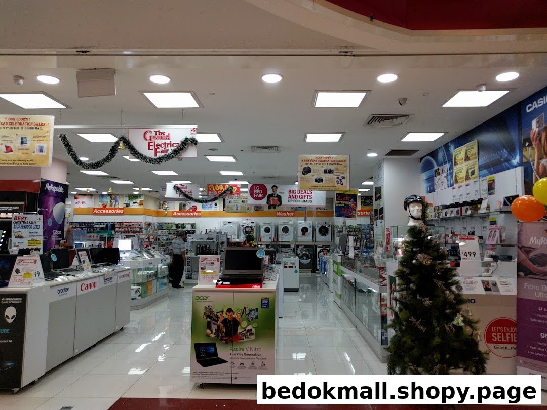 Interior view of an electronics store with various products and displays.