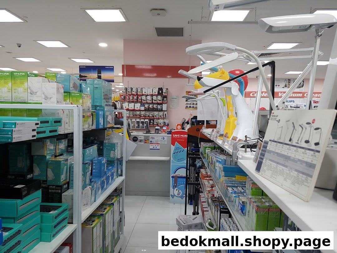Interior view of an electronics store with shelves of products and display items.