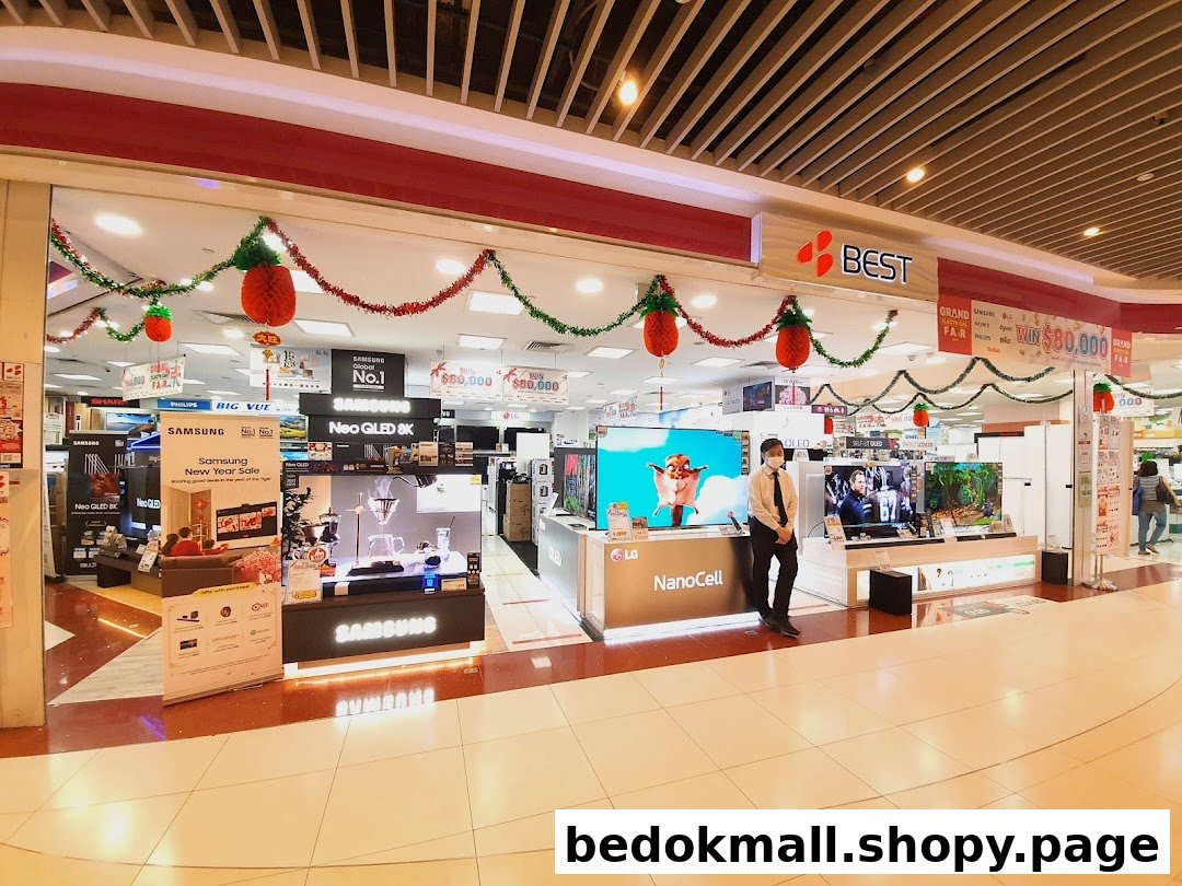 Shop entrance decorated for a sale, showing electronics and a staff member.
