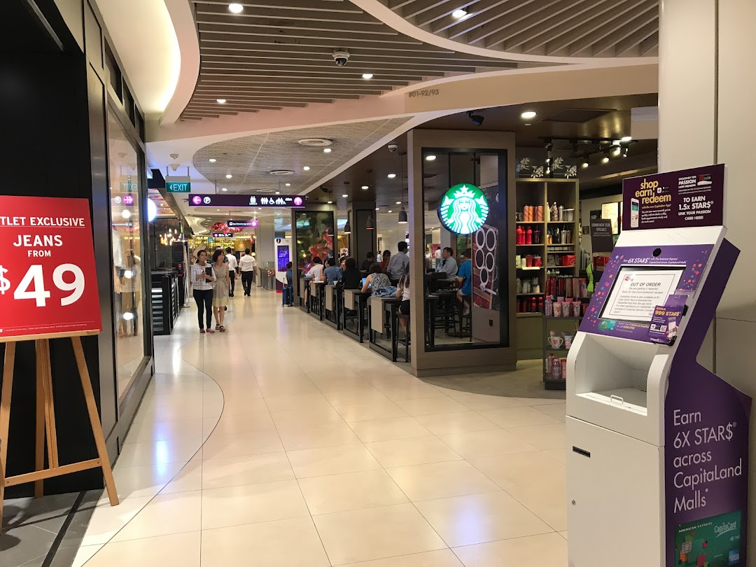 Mall interior with shops, people, and a loyalty program kiosk.
