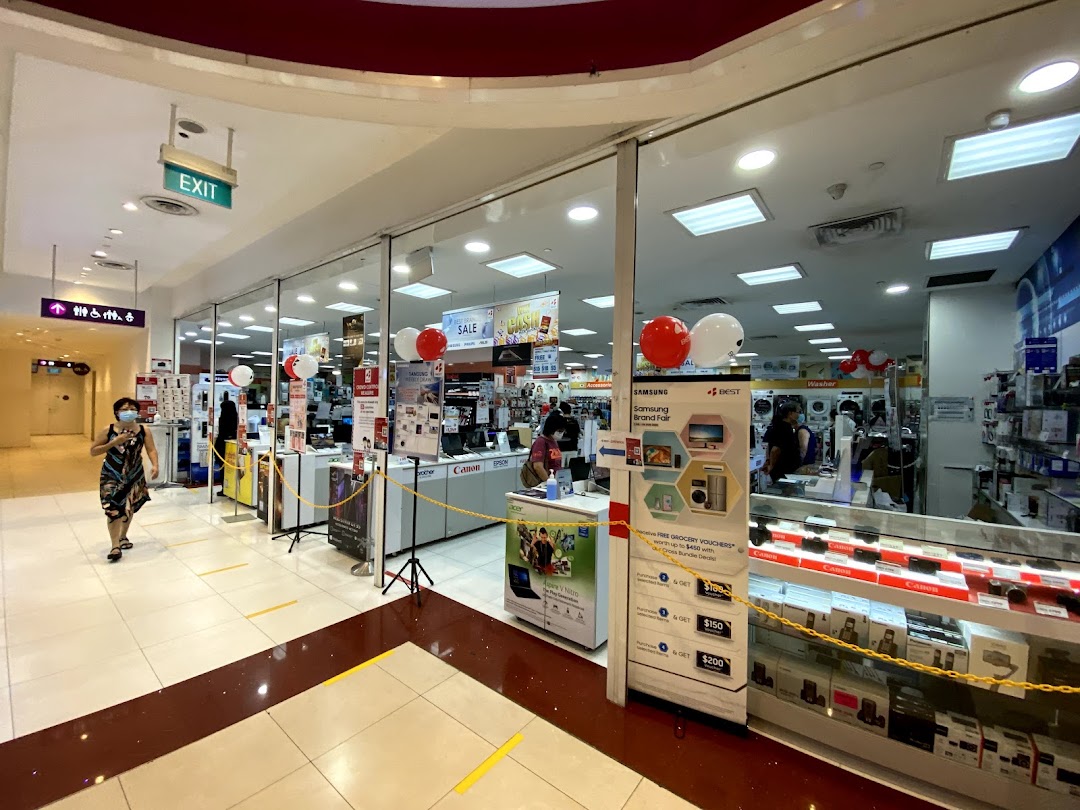 Shop entrance of Best Denki with promotional displays and customers.