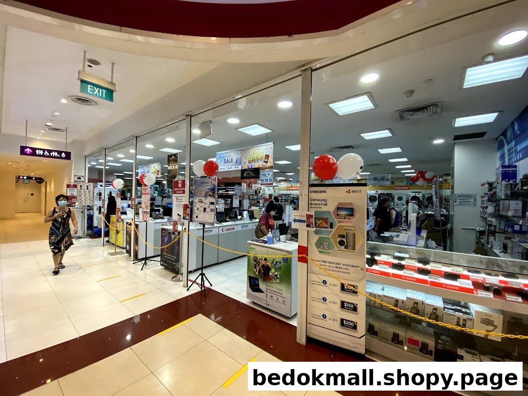 Shop entrance of Best Denki with promotional displays and customers.