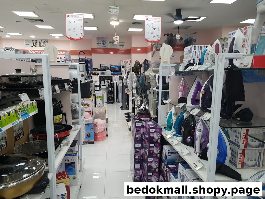 Interior of an electronics store displaying home appliances and kitchenware.