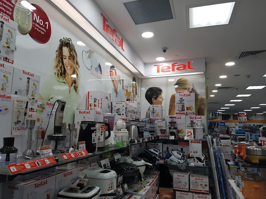 Interior view of a Best Denki store, showing Tefal small appliances on display.